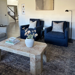 Black floor lamp beside navy accent chairs
