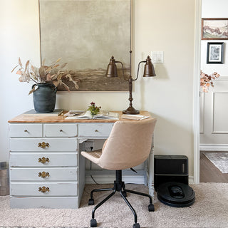 Double arm adjustable desk lamp providing task lighting on home office desk