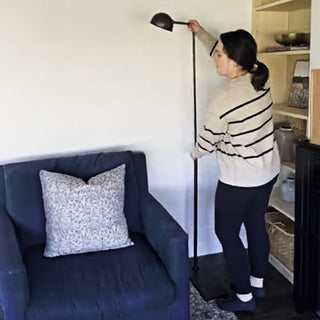 Adjustable black floor lamp demonstration in living room
