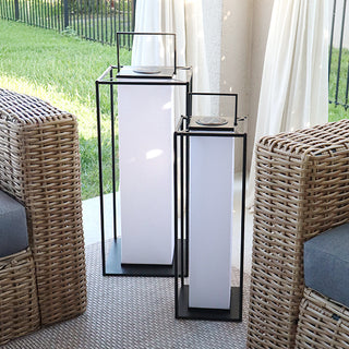 Minimalist solar lantern set beside wicker furniture