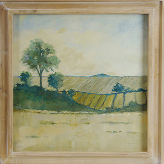 Close-up of watercolor landscape painting featuring green trees yellow fields and soft blue sky in rustic wooden frame