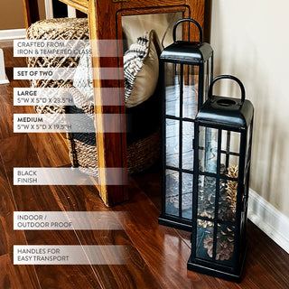 Black iron and tempered glass decorative lantern set displayed indoors beside a console table, showing product sizes and features