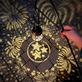 Solar lantern projecting star patterns patio lighting