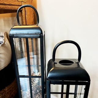 Close-up of black metal lantern tops with carrying handles, showcasing construction and finish for home décor product listing