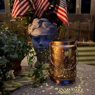 Patriotic metal lantern glowing with American flags