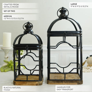 Two graduated height black metal lanterns with natural wood bases and ornamental geometric fretwork 15.5 and 19.5 inches tall