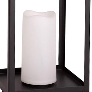 Close-up of white LED candle inside black metal lantern