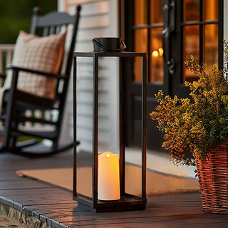 Large black metal lantern with glowing LED candle