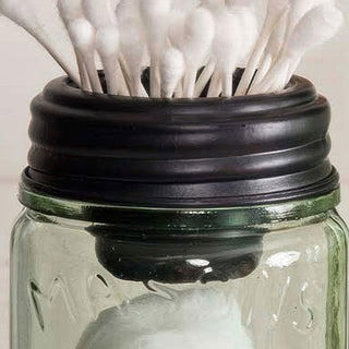 Mason jar lid holding cotton swabs