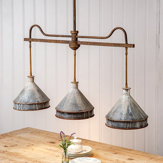 Industrial farmhouse triple pendant light over dining table