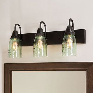Three-light mason jar vanity lighting over bathroom mirror