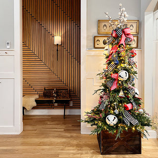 Full product shot showing battery operated wall sconces lighting decorative entry space with Christmas tree