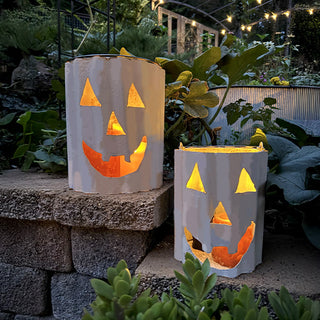 Glowing white metal jack-o’-lantern luminaries