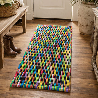 Eco-friendly woven mat made from upcycled flip flop materials in entryway