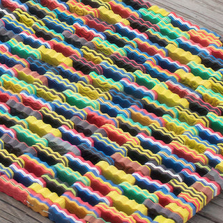  Close up of colorful recycled foam strips in handwoven mat texture