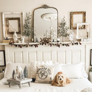 Vintage farmhouse bedroom mantel with ornate gold mirror