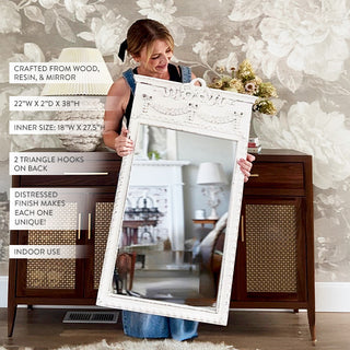 Woman holding distressed white farmhouse wall mirror