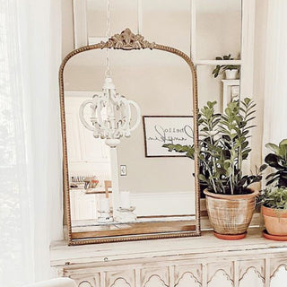 Vintage gold mirror styled on rustic console table