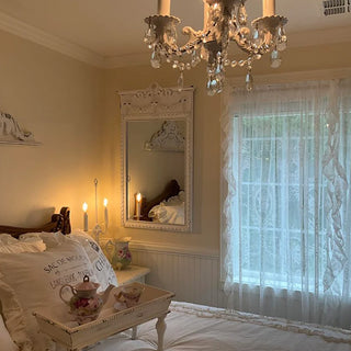 Vintage white wall mirror in romantic bedroom