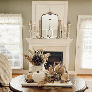Antique gold arched mirror styled on black shiplap wall