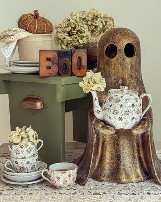 ghost with vintage teapot vintage teacups pumpkins and Halloween decor