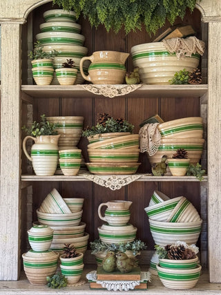 birds statue inside hutch with vintage stoneware bowls