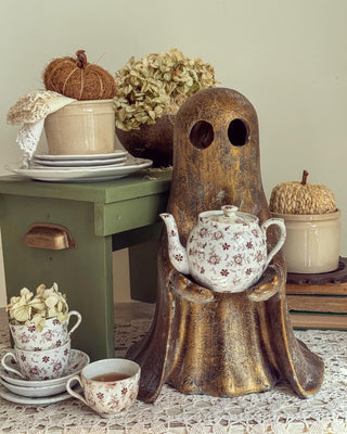ghost with vintage teapot vintage teacups pumpkins and Halloween decor