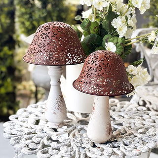 Rustic metal mushroom garden decor set on patio table