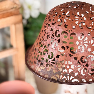 Perforated rust metal mushroom cap close-up