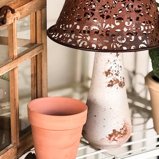 Distressed white metal mushroom stem close-up