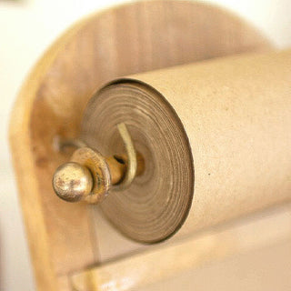 Close-up detail of brass metal rod mechanism on wooden recipe paper holder