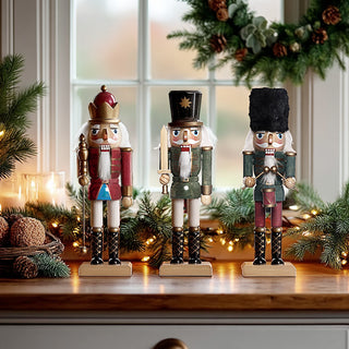 Traditional wooden nutcracker soldier set of three displayed on rustic table with Christmas greenery and warm lights