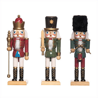 Complete set of three wooden nutcracker soldiers showing red green and black designs with gold accents