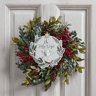 Metal Christmas wreath ornament with Oh Holy Night text and lamb design on white distressed door