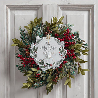 Close up hand painted metal Christmas ornament with lamb botanical wreath and star topper