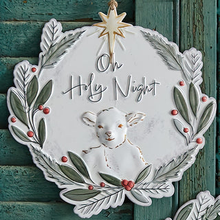 Distressed white metal ornament with religious Christmas message and red berry accents