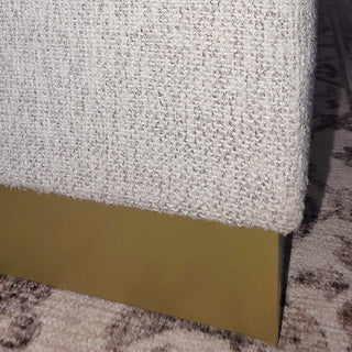 Textured cream fabric ottoman with gold base