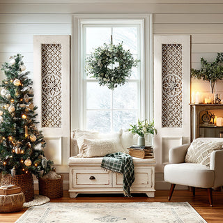 Pair of tall white distressed wood panels with metal lattice flanking window in bright farmhouse living room