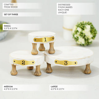 Set of three distressed white wood risers with gold numbered plates 1 2 3 showing dimensions on white background