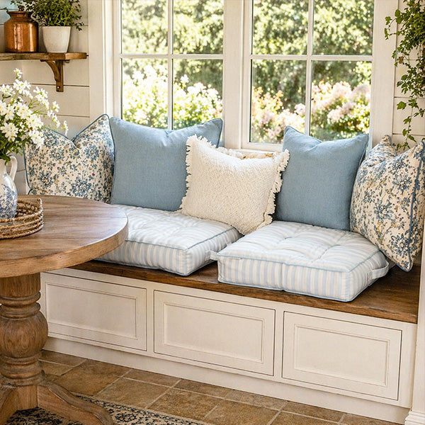 Blue and white striped tufted floor cushion on white background