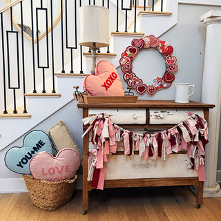 Valentine entryway decor with heart pillows and wreath