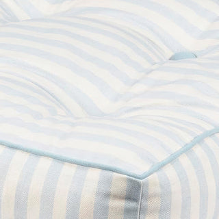 Close-up of tufted cotton cushion showing stripe pattern and texture