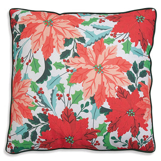 Close-up of coral red poinsettia floral Christmas pillow with teal holly berries and dark green piping trim
