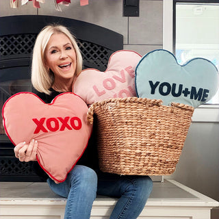 Woman holding Valentine heart pillows home decor