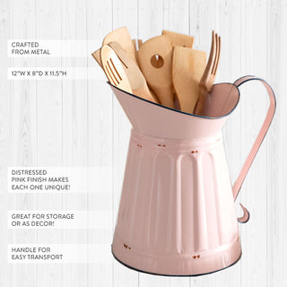 Vintage style pink pitcher holding wooden kitchen utensils with distressed finish details
