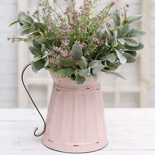 Pink metal pitcher vase styled with eucalyptus and lavender floral arrangement
