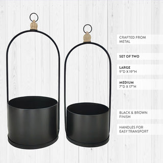 Modern black metal planters with carved wood accent detail close-up