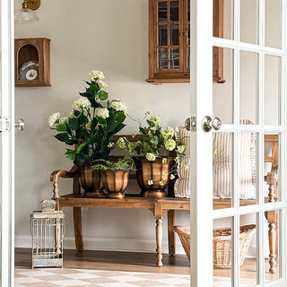 Farmhouse bench styled with bronze flower pots