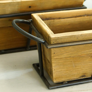 Close-up detail of rustic wood planter box corner showing natural wood grain and curved metal handle