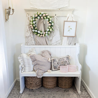 Farmhouse entry bench styled with pink bunny baskets